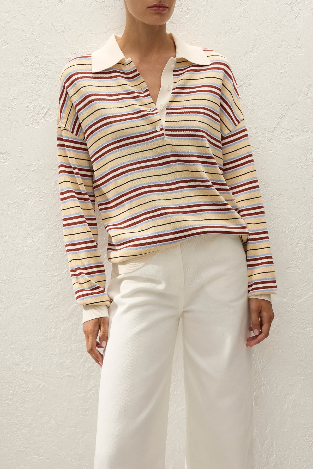 Close front view highlighting the striped knit pattern, contrasting cream collar, button placket and relaxed dropped shoulders.