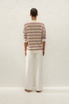 Back view showing the oversized striped silhouette, cream collar, ribbed hem and relaxed long sleeves.