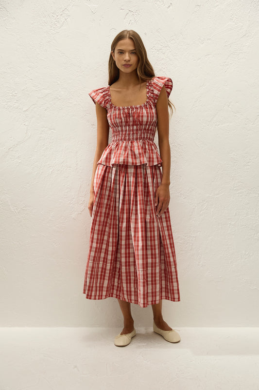 Faithfull The Brand Cales Skirt in Ines Check Terra Rosso, front styling view on model.