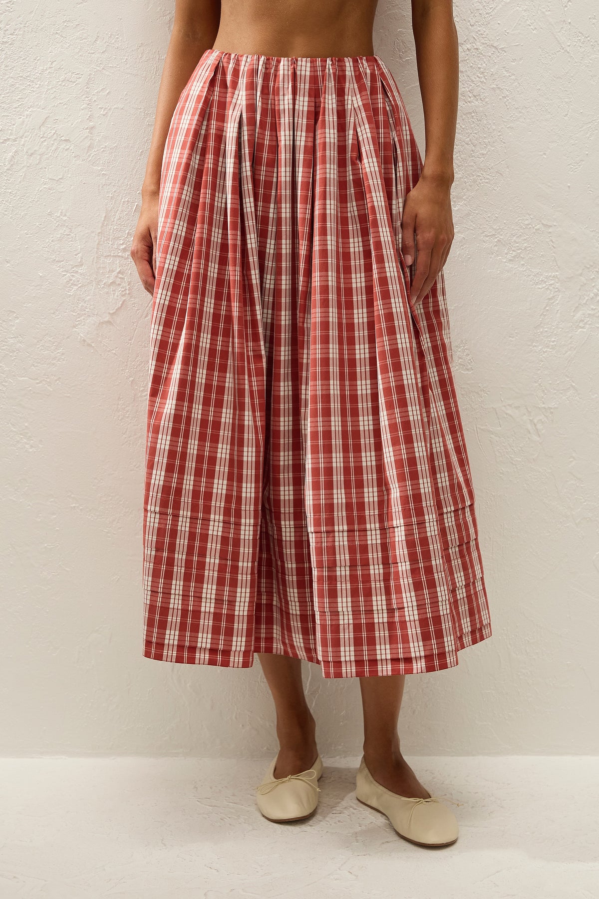Faithfull The Brand Cales Skirt in Ines Check Terra Rosso, close-up front view on model
