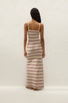 Back view showing the fitted shape, straight back neckline and long striped maxi skirt.