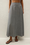 A black and white gingham midi skirt is shown from the front with a flowing A-line silhouette.
