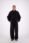 Jasmine Alexa Bailey Bomber Jacket in Black, full-length front view on model with collar folded down.
