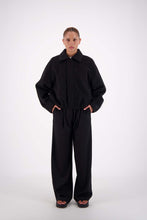 Jasmine Alexa Bailey Bomber Jacket in Black, full-length front view on model with collar folded down.
