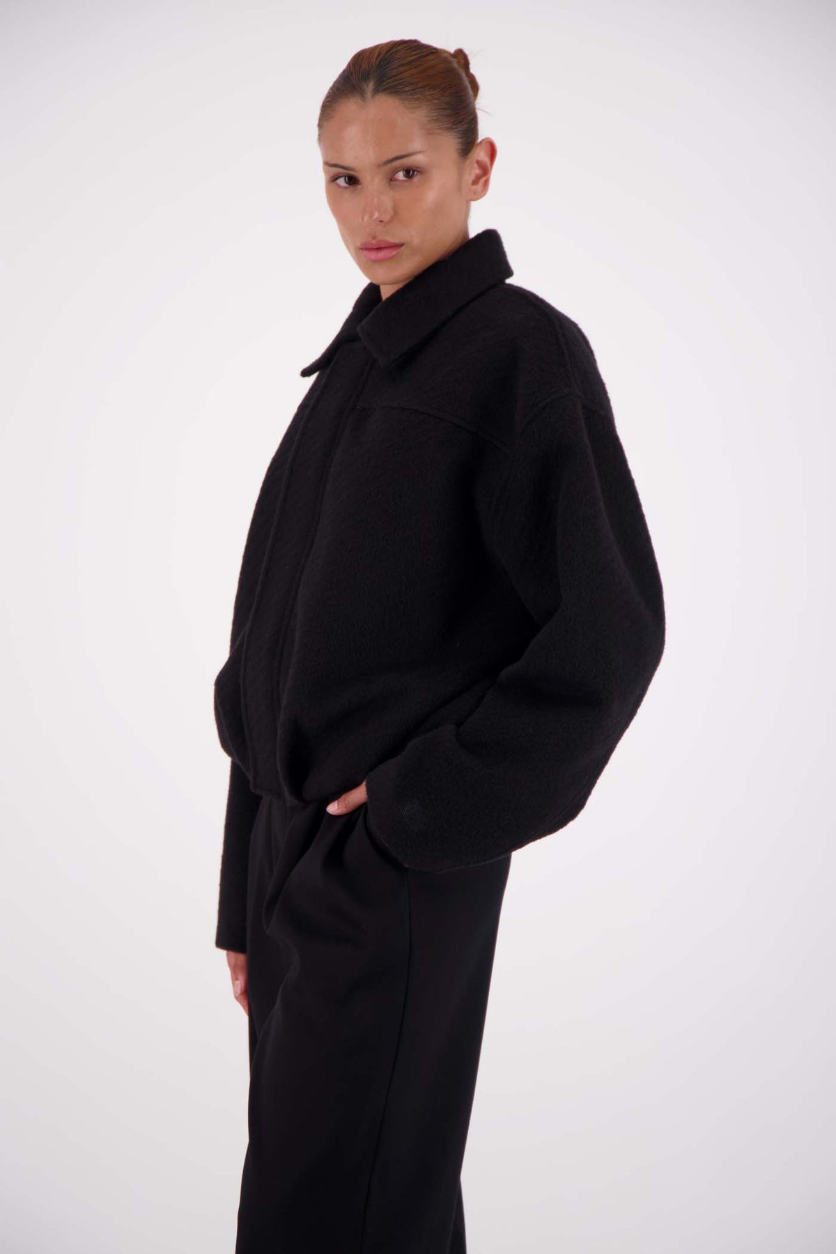 Jasmine Alexa Bailey Bomber Jacket in Black, cropped side view showing the relaxed silhouette.
