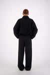 Jasmine Alexa Bailey Bomber Jacket in Black, full-length back view on model.
