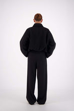 Jasmine Alexa Bailey Bomber Jacket in Black, full-length back view on model.
