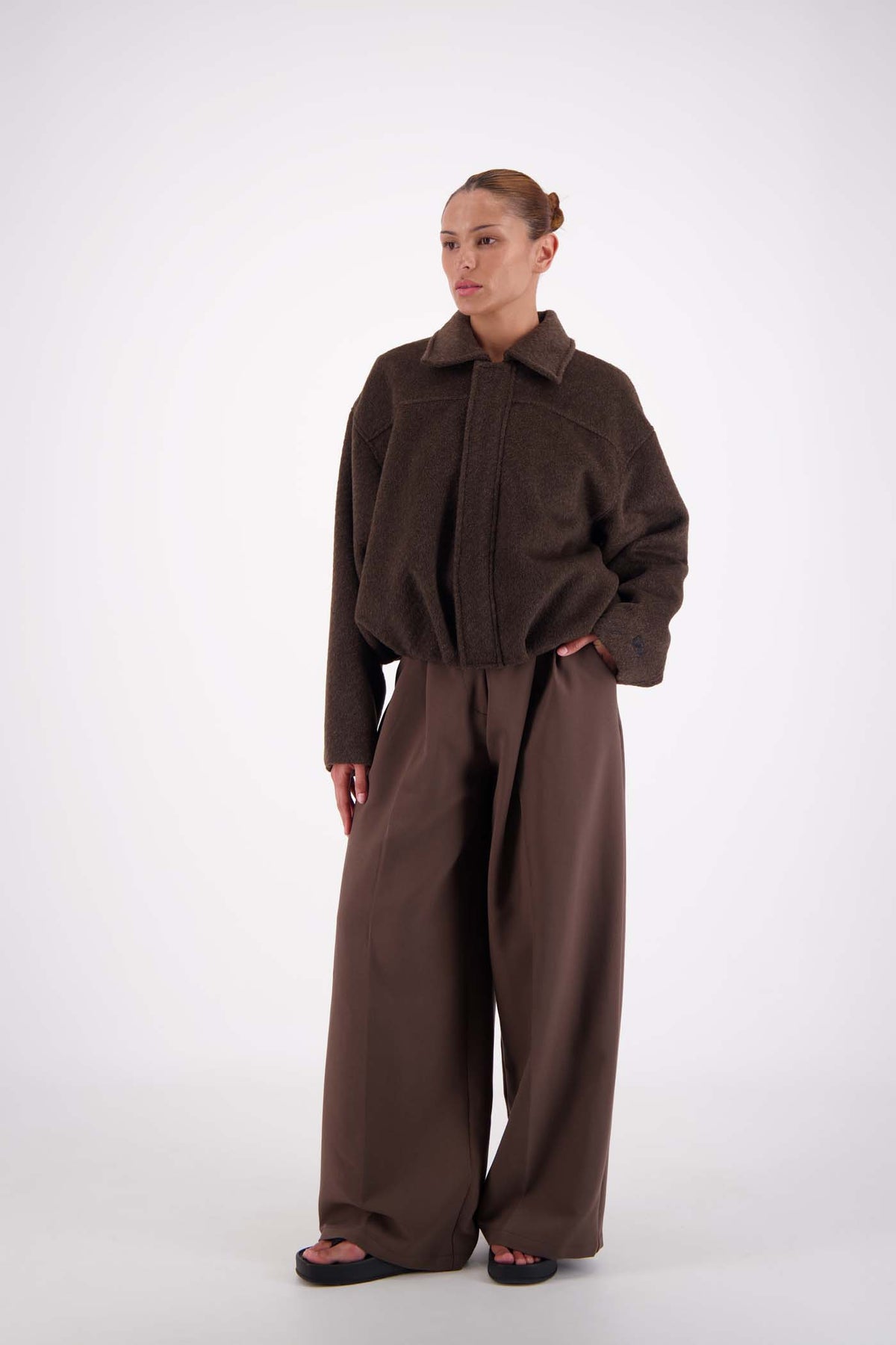 Jasmine Alexa Bailey Bomber Jacket in Brown, angled full-length front view on model.
