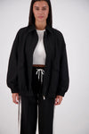Jasmine Alexa Ischia Bomber Jacket in Black, open front view showing the zip and patch pockets.
