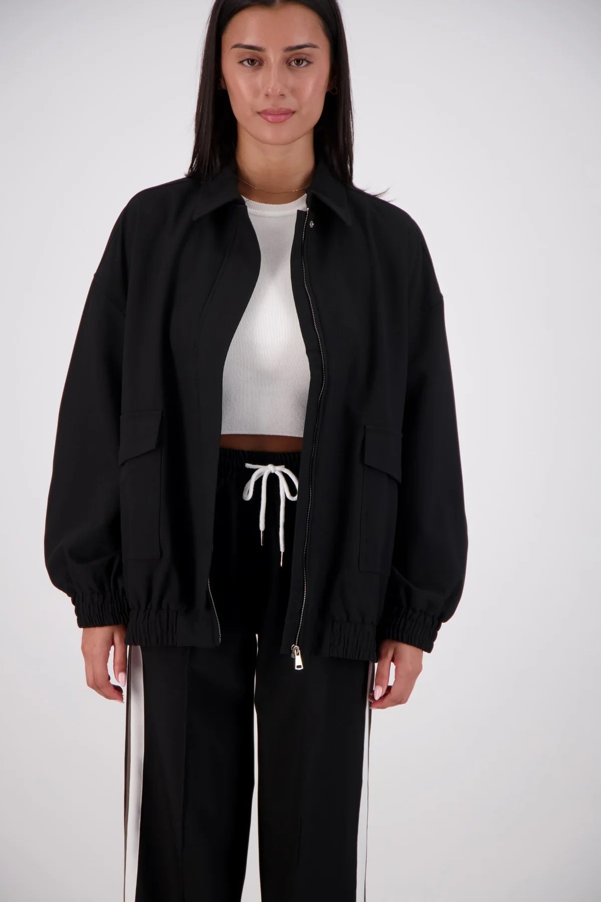 Jasmine Alexa Ischia Bomber Jacket in Black, open front view showing the zip and patch pockets.
