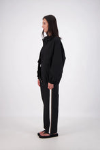 Jasmine Alexa Ischia Bomber Jacket in Black, full-length side view on model.
