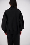 Jasmine Alexa Ischia Bomber Jacket in Black, back view showing the oversized silhouette and elasticated hem.