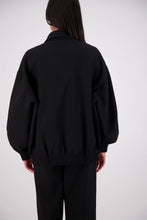 Jasmine Alexa Ischia Bomber Jacket in Black, back view showing the oversized silhouette and elasticated hem.