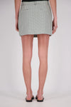 A rear view of a white and mint checked mini skort showing the back waistband, belt loops and two welt-style pockets.