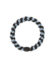 Brown, sea blue and black woven hair tie shown in a circular shape with a smooth branded bead.