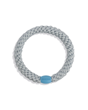 Baby Frost woven hair tie in a pale silver-blue shade with a light blue bead on a clean product background.