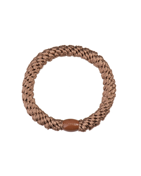 Nougat brown woven hair tie shown in a circular product view on a clean white background with a matching brown bead.