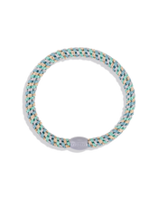 Slim mixed teal and gold glitter woven hair tie with a light bead shown in a circular product view.