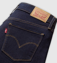 Close-up of the Darkest Sky jeans, showing the dark indigo denim, contrast stitching, back pocket with arcuate detailing, red tab, belt loops and branded leather waistband patch.
