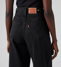 Close-up of Levi’s black high-rise wide-leg jeans, showing the back pockets, red tab, belt loops and branded waistband patch, back detail view