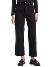 A model wears the Levi’s Ribcage Straight Ankle Jeans in Black with a black long-sleeve top and loafers in a front studio view.
