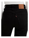 A close-up shows the back pockets, Levi’s tab and branded waistband patch on the black jeans.