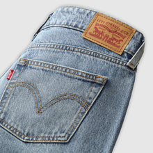 Close-up of Levi's jeans with brand label on a light gray background
