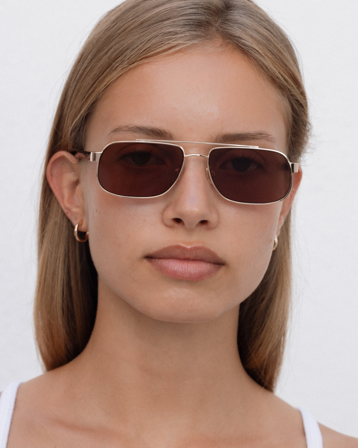 Lu Goldie Evangeline Sunglasses in Coffee — a hot girl take on the classic aviator, she brings an air of authority to any outfit.