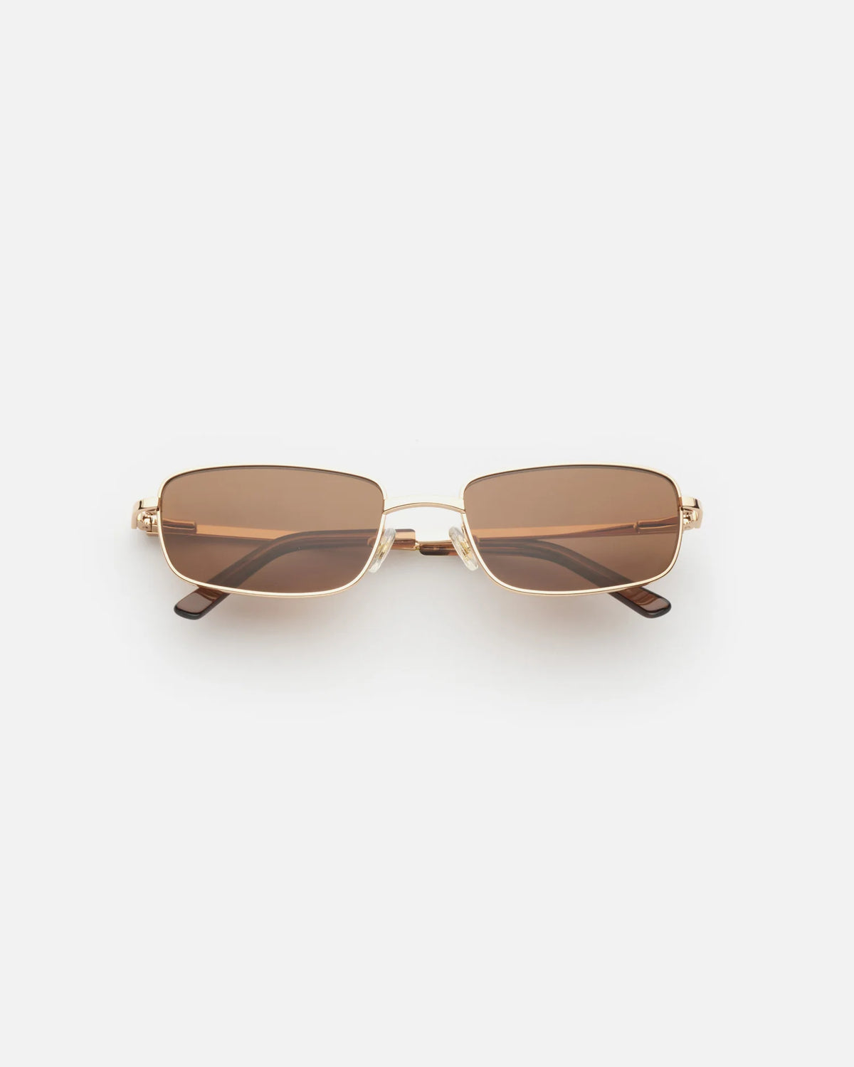 Lu Goldie Yuki Sunglasses in Coffee — she can pull off any look— hyper feminine, iconic 90s or futuristic cyber punk.