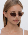 Lu Goldie Yuki Sunglasses in Coffee — she can pull off any look— hyper feminine, iconic 90s or futuristic cyber punk.