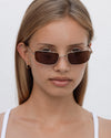 Lu Goldie Yuki Sunglasses in Coffee — she can pull off any look— hyper feminine, iconic 90s or futuristic cyber punk.