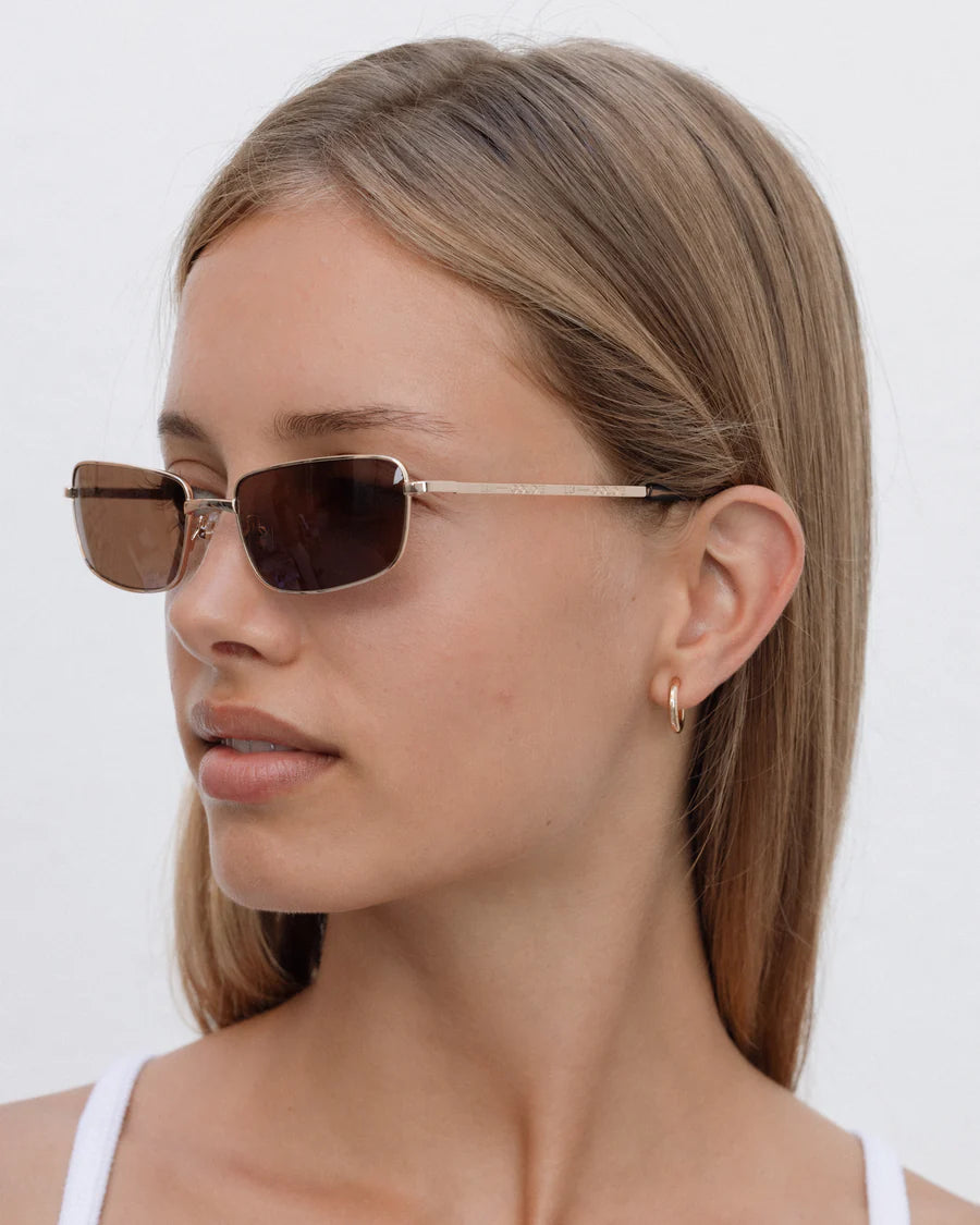 Lu Goldie Yuki Sunglasses in Coffee — she can pull off any look— hyper feminine, iconic 90s or futuristic cyber punk.