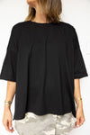 Luna Lane The Basic Tee in Black — an everyday essential with a modern twist, the Basic Tee features a relaxed drop shoulder fit, rounded neckline, and a stepped hemline for an effortlessly flattering shape.
