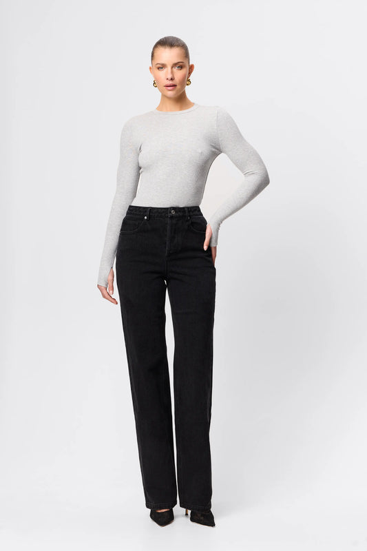 Person wearing a white long-sleeve top and black pants on a white background