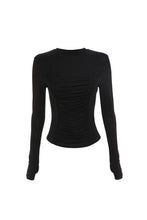 The black long-sleeve top is displayed from the front, showing its fitted shape and ruched centre panel.