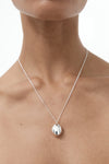 Nina Gordon Drop Necklace — a weighty drop pendant suspended from an adjustable fine chain, offering a modern style for effortless wear.