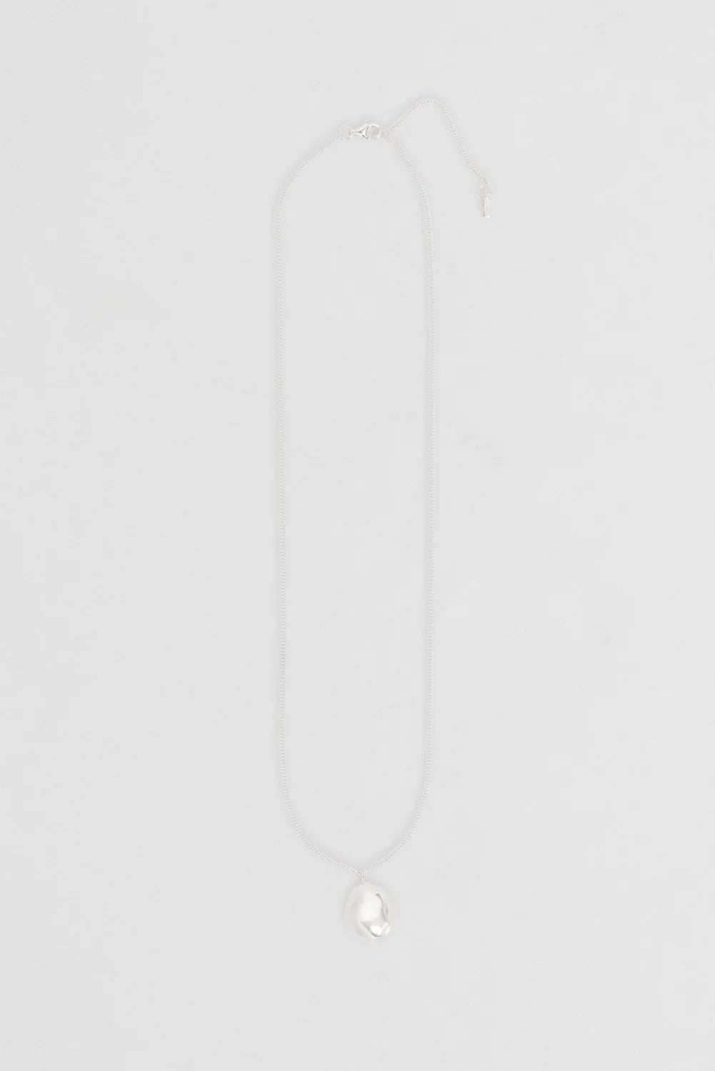 Nina Gordon Drop Necklace — a weighty drop pendant suspended from an adjustable fine chain, offering a modern style for effortless wear.