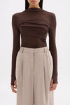 Close front view showing the raised neckline, draped bust panel and fitted silhouette.