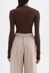 Back view showing the clean fitted shape, long sleeves and hip-length finish.