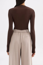 Back view showing the clean fitted shape, long sleeves and hip-length finish.