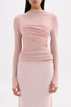 Close front view showing the raised neckline, draped bust panel and fitted waist.