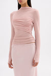 Three-quarter view highlighting the soft draped detailing and figure-hugging silhouette.