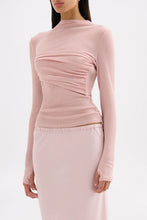 Three-quarter view highlighting the soft draped detailing and figure-hugging silhouette.