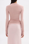 Back view of the pink long sleeve top showing its clean fitted shape and hip-length finish.