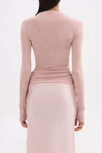 Back view of the pink long sleeve top showing its clean fitted shape and hip-length finish.