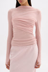 Close front view of the pink top showing the lightweight jersey texture, draped bust and long sleeves.