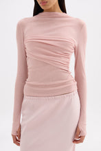 Close front view of the pink top showing the lightweight jersey texture, draped bust and long sleeves.