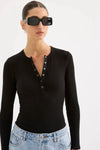 Nude Lucy Binx Long Sleeve in Black — a refined everyday essential with a close, figure-hugging silhouette, the Nude Lucy Binx Long Sleeve in Black is designed with a crew neckline and fitted long sleeves.