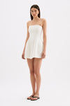 White strapless mini dress shown from a three-quarter front view, highlighting the fitted bodice, flared skirt and short length.