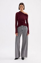 A model wears the Nude Lucy Calvi Boyfriend Jean in Steel with a burgundy long-sleeve top in a full-length front studio view.
